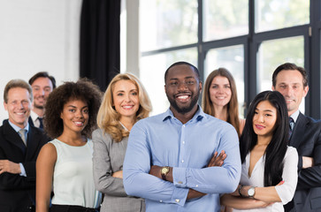 african american businessman boss with group of business people in creative office, successful mix r