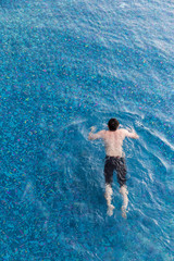 view from top pool with man swimming