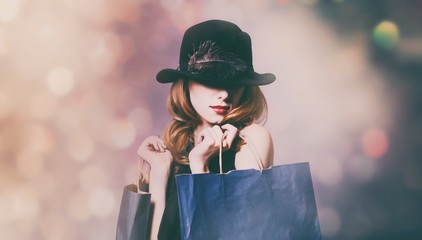 woman in black dress with shopping bags