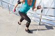 © 4frame group - Full length shot of healthy young woman climbing up and running on stairs