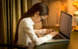© Kyrylo Ryzhov - Schoolgirl sitting behind table and using laptop at cabinet