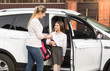 © Кирилл Рыжов - Young mother taking daughter to home from school by car