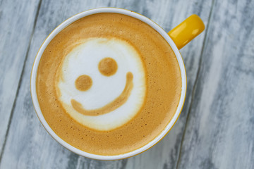 Latte art smiley face. Top view of coffee. Surprising facts about caffeine.