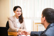 © stockartstudio - smiling business woman shakes her hand at the interview