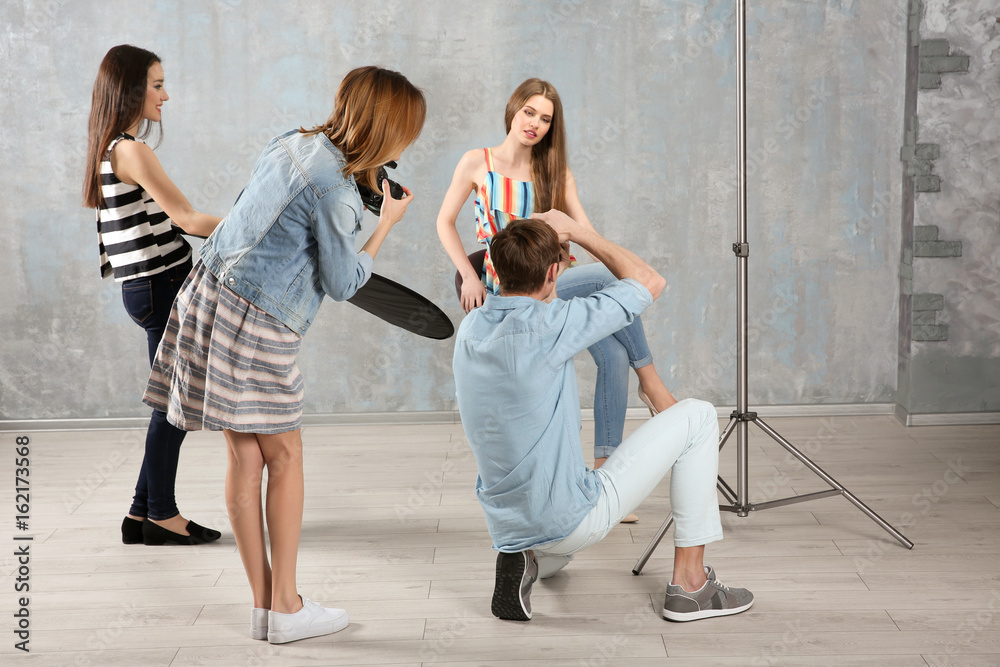 Group of students taking photo of model during photography classes