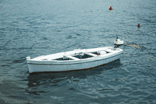 Single Boat Floating On The Water Surface In Montenegro Background.