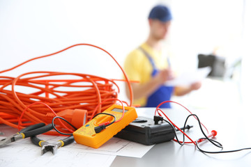 Wall Mural - Electric equipment and blurred electrician on background