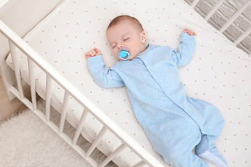 cute little baby sleeping in cradle at home