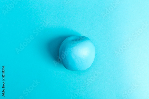 Fotografie, Obraz Funky fruit painted apple on a bright blue background