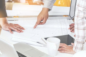 Team engineers working with construction tools on table