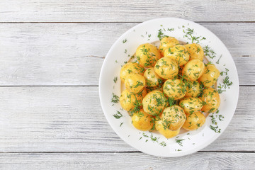 Canvas Print - tasty new potatoes on white plate