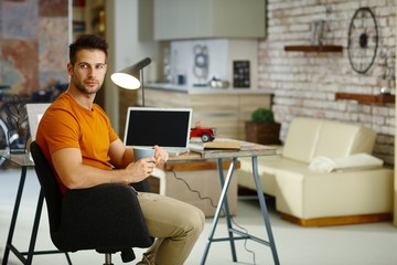 Thoughtful young man at home