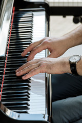 Canvas Print - music performer hands playing grand piano. closeup view.