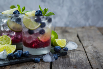 Wall Mural - Blueberry mojito on rustic wood background