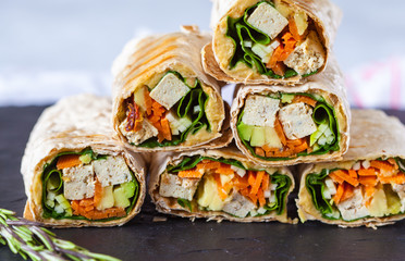 Healthy vegan tofu tortilla wraps with tofu and vegetables. Love for a healthy raw food concept.