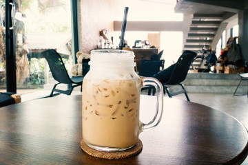 Wall Mural - Ice cappuccino coffee on the table in a coffee shop