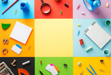 school supplies at abstract colorful background