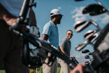 Smiling Players Going To The Golf Course, Bag With Clubs At Foreground