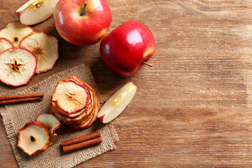 Sticker - Composition with tasty apple chips and cinnamon on wooden table