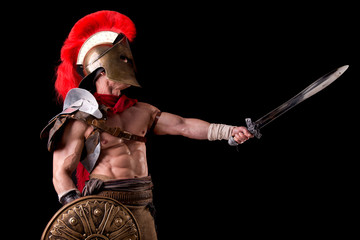 gladiator posing isolated in dark