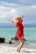 © Cristina Jurca - Outdoor portrait of young beautiful blonde woman jumping on the beach, fit sporty healthy body in bikini, woman enjoys wind, freedom, vacation, summertime fun concept.