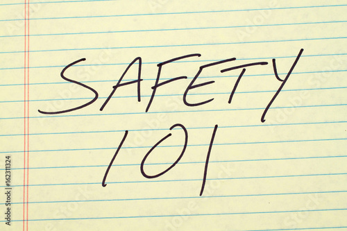 The words "Safety 101" on a yellow legal pad плакат