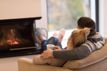 Young couple  in front of fireplace