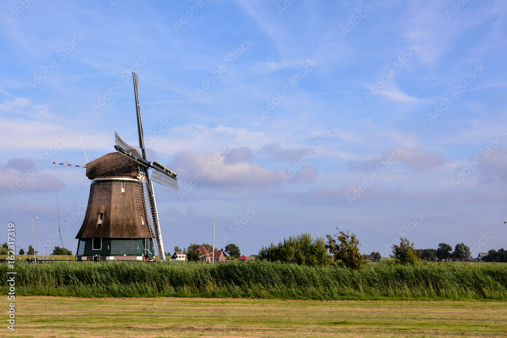 Photograph of a Classic Vintage Windmill in Holland - obrazy, fototapety, plakaty 