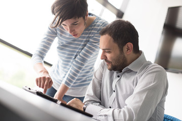 Two Business People Working With Tablet in startup office