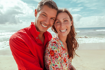 Wall Mural - spring summer couple laughing on the beach