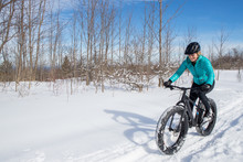 Beautiful Woman Riding Her Fat Bike In The Snow