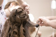 © mak_alexandra - a hairdresser does a hairstyle for a girl in a hairdresser's