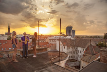 Man Playing The Saxophone On Rooftop At Sunset, Osijek, Croatia