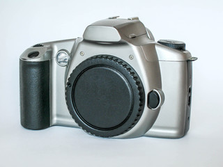 Reflex camera. A silver camera on a white background. Isolated. A camera without a lens. Body. Зеркальный фотоаппарат. Фотоаппарат серебристого цвета на белом фоне. Фотоаппарат без объектива. Body.