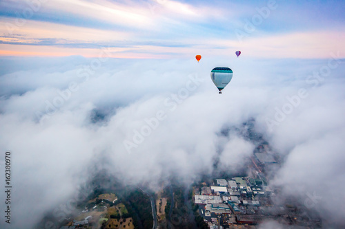 Hot air balloon in clouds over Melbourne, Australia © James Ser