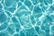 Detal of swimming pool water and sun reflecting on the surface