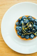 Canvas Print - Sweet dessert with blueberry tart in white plate