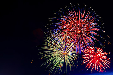 Brightly colorful fireworks of various colors in the night sky