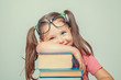 © Myst - smiling beautiful cute little girl leaning on thick books
