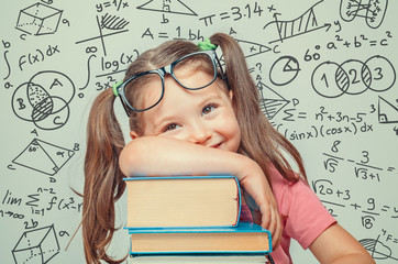 Wall Mural - beautiful cute little genius girl with books. Math formulas, problems around her
