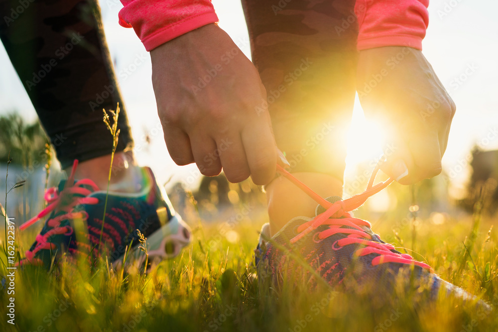 Running shoes - woman tying shoe laces
