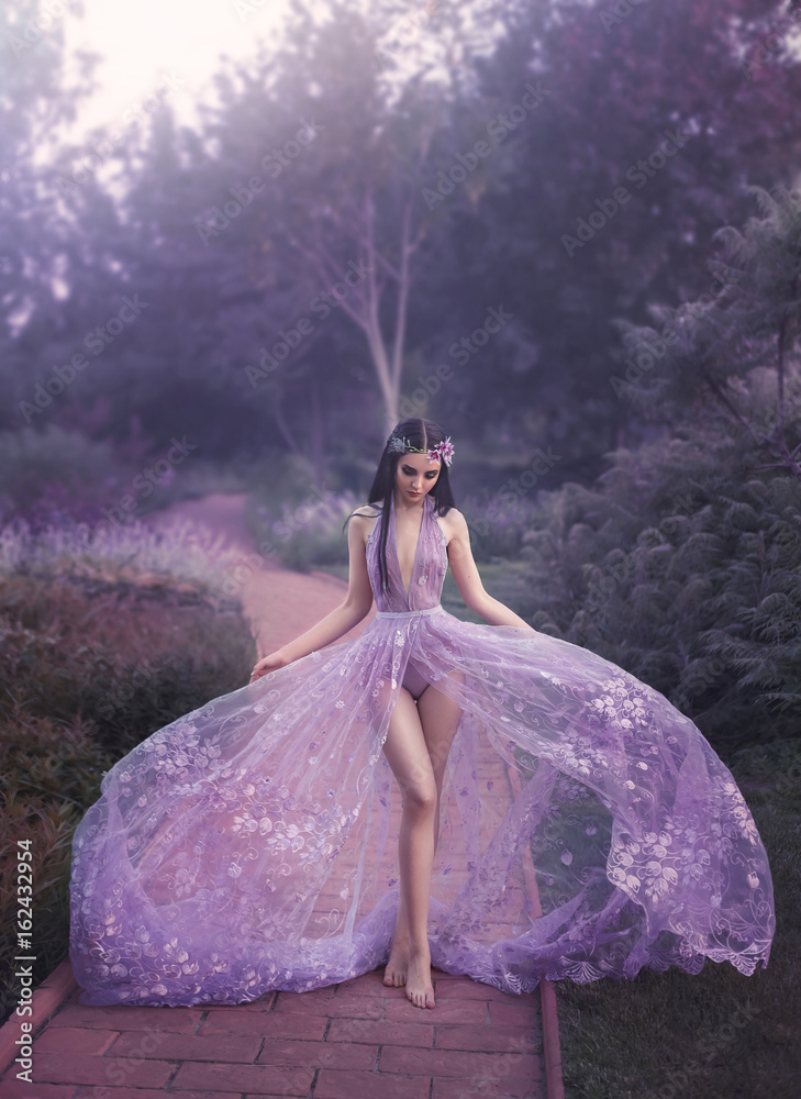Fantasy girl in a fairy garden. Young elf in a beautiful purple dress with  a long train. Creative colors artistic processing Stock Photo | Adobe Stock