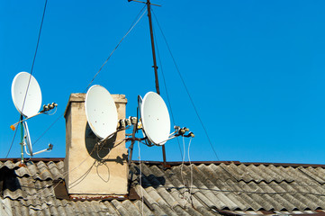 Satellite dishes on the old roof