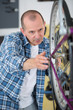© auremar - handyman fixing bike wheel in his garage