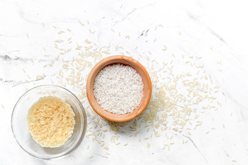 homemade paella ingredients composition with rice in bowl on white table background top view mock-up