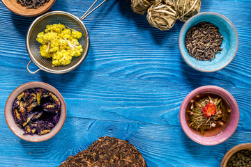 Wall Mural - Drink herbal tea with brew blue wooden table background top view mockup