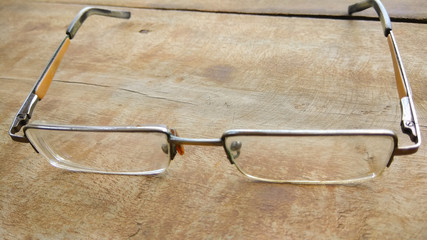 eye glasses on wooden background.  