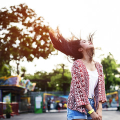 Wall Mural - Young Girl Hair Fling Funfair Festive Playful Happiness Concept