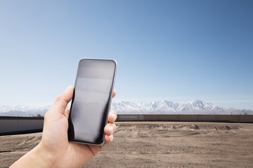 Wall Mural - mobile phone with snow mountain