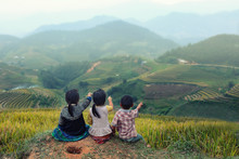 Three Children Looking Forward On The Top Of Terraced Of Rice Field At Vietnam.Together Concept.